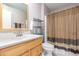 Bathroom features a neutral-colored vanity, toilet, and shower with a large mirror at 10425 W Desert Forest Cir, Sun City, AZ 85351