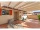 Charming covered front porch with tiled floor and seating, perfect for relaxing outdoors at 10425 W Desert Forest Cir, Sun City, AZ 85351