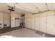 Spacious garage with ample storage provided by built-in cabinets and shelves, great for organization at 10425 W Desert Forest Cir, Sun City, AZ 85351