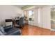 Office space with natural light, tile floors, and a sliding glass door at 10425 W Desert Forest Cir, Sun City, AZ 85351