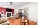 Comfortable living room with fireplace, TV, and comfortable seating at 10425 W Desert Forest Cir, Sun City, AZ 85351