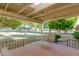 Charming covered patio with a swing, perfect for relaxing and enjoying the serene outdoor views at 10425 W Desert Forest Cir, Sun City, AZ 85351