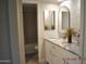Bathroom featuring granite countertops, white cabinetry, and a mirror over the sink at 10444 N 69Th St # 128, Paradise Valley, AZ 85253