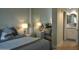 Cozy bedroom with a mirrored closet reflecting the bed and a glimpse of an adjacent bathroom at 10444 N 69Th St # 128, Paradise Valley, AZ 85253
