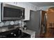Modern kitchen showcasing stainless steel appliances, stylish backsplash, and granite countertops at 10444 N 69Th St # 128, Paradise Valley, AZ 85253