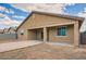 Stucco home exterior showing backyard features like patio, wall and partially xeriscaped ground at 10528 W Crown King Rd, Tolleson, AZ 85353
