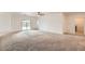 Spacious living room with neutral carpet, a ceiling fan, and sliding glass doors at 10528 W Crown King Rd, Tolleson, AZ 85353