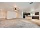 This home's living room features tile floors, carpeted area, and the kitchen in the background at 10528 W Crown King Rd, Tolleson, AZ 85353