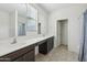 Spacious bathroom featuring dual sinks, vanity with generous countertop, shower/tub, and tiled floors at 10961 W Taylor St, Avondale, AZ 85323