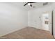 Neutral bedroom featuring plush carpet, ceiling fan and a bright, airy feel with walk in closet in the back at 10961 W Taylor St, Avondale, AZ 85323