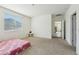 Bright and airy bedroom featuring carpet flooring and a large window at 10961 W Taylor St, Avondale, AZ 85323