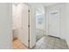 Clean, tiled entryway featuring the front door and an adjacent half bathroom at 10961 W Taylor St, Avondale, AZ 85323