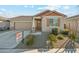 Charming single-story home with a well-manicured front yard, concrete driveway, and attached two-car garage at 10961 W Taylor St, Avondale, AZ 85323