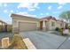 Charming single-story home with a well-manicured front yard, concrete driveway, and attached two-car garage at 10961 W Taylor St, Avondale, AZ 85323