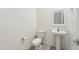 Half bathroom with pedestal sink and ceramic tile flooring at 10961 W Taylor St, Avondale, AZ 85323