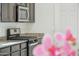 Close-up of the modern gas range and granite countertops in this updated kitchen at 10961 W Taylor St, Avondale, AZ 85323
