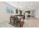 Bright kitchen and dining area featuring granite countertops and modern light fixtures at 10961 W Taylor St, Avondale, AZ 85323
