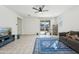 Open living area with ceiling fan, tile flooring, and access to the backyard at 10961 W Taylor St, Avondale, AZ 85323