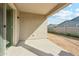 Covered patio with sliding glass doors and neutral colored paint at 10961 W Taylor St, Avondale, AZ 85323