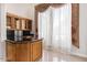 Bar area with wood cabinets and granite countertops. Perfect for entertaining at 11054 E North Ln, Scottsdale, AZ 85259