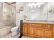 Well-lit bathroom features a tiled shower, a single sink vanity and granite countertops at 11054 E North Ln, Scottsdale, AZ 85259