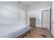 Neutral bedroom with a minimalist wooden dresser, gray walls, and tile flooring for a simple aesthetic at 11054 E North Ln, Scottsdale, AZ 85259