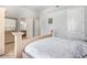 Bright bedroom with tile floors and a decorative white bed frame is illuminated by natural light at 11054 E North Ln, Scottsdale, AZ 85259