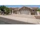 Beautiful home features a paver driveway, stone accents, lush landscaping, and a tile roof at 11054 E North Ln, Scottsdale, AZ 85259