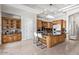 Bright kitchen features a large island with seating, ample storage, and stainless steel appliances at 11054 E North Ln, Scottsdale, AZ 85259