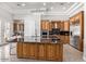 Spacious kitchen featuring a large island with seating and wood cabinetry at 11054 E North Ln, Scottsdale, AZ 85259