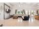 Bright living room with TV and an open layout to the dining room and bar area at 11054 E North Ln, Scottsdale, AZ 85259