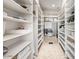 This walk-in closet features ample storage with built-in shelving, perfect for organizing any wardrobe at 11054 E North Ln, Scottsdale, AZ 85259