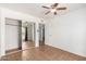 Open bedroom featuring tan tiling, a ceiling fan and a mirrored closet at 1159 W Emelita Ave, Mesa, AZ 85210