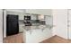 Kitchen with granite countertop, a breakfast bar, and black appliances at 1159 W Emelita Ave, Mesa, AZ 85210