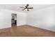 Bright living room with tile flooring, neutral paint, ceiling fan, and view to the kitchen at 1159 W Emelita Ave, Mesa, AZ 85210