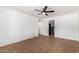 Bright living room with tile flooring, neutral paint, ceiling fan, and kitchen access at 1159 W Emelita Ave, Mesa, AZ 85210