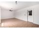 Bright living room with tile flooring, neutral paint, ceiling fan, and back patio access at 1159 W Emelita Ave, Mesa, AZ 85210