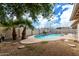Refreshing backyard pool is surrounded by gravel landscaping and mature palm trees at 1159 W Emelita Ave, Mesa, AZ 85210