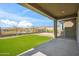 Inviting covered patio and backyard, with lush turf and views of mountain landscape, perfect for outdoor gatherings at 11910 E Amanda Rd, Gold Canyon, AZ 85118