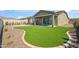 Attractive backyard with pristine turf, a covered patio, and beautiful mountain views, ideal for enjoying the outdoors at 11910 E Amanda Rd, Gold Canyon, AZ 85118