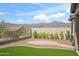 Landscaped backyard with synthetic grass, mountain views, and a brick patio offers space to relax at 11910 E Amanda Rd, Gold Canyon, AZ 85118