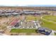 Aerial view of a well-kept community park and amenities, nestled among homes and desert landscape at 11910 E Amanda Rd, Gold Canyon, AZ 85118