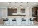 Modern kitchen features a large island with seating, stainless steel appliances and dark wood cabinets at 11910 E Amanda Rd, Gold Canyon, AZ 85118