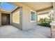 Covered porch featuring stone accents, tan stucco, and a brown front door at 11910 E Amanda Rd, Gold Canyon, AZ 85118