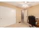 Bedroom with closet, ceiling fan, and desk area, providing a comfortable and functional space at 1347 E Vernoa St, San Tan Valley, AZ 85140
