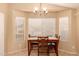 This neutral dining room offers a cozy space with a chandelier and natural lighting at 1347 E Vernoa St, San Tan Valley, AZ 85140