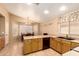 This kitchen offers wooden cabinets, neutral countertops, black appliances, and tile flooring at 1347 E Vernoa St, San Tan Valley, AZ 85140