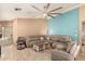 Open living room features tile floors, neutral walls, and a cozy sectional couch at 1347 E Vernoa St, San Tan Valley, AZ 85140