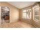This bright living room offers an open floor plan to the kitchen and a large window for natural light at 1347 E Vernoa St, San Tan Valley, AZ 85140