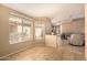 This bright living room offers an open floor plan to the kitchen and a large window for natural light at 1347 E Vernoa St, San Tan Valley, AZ 85140